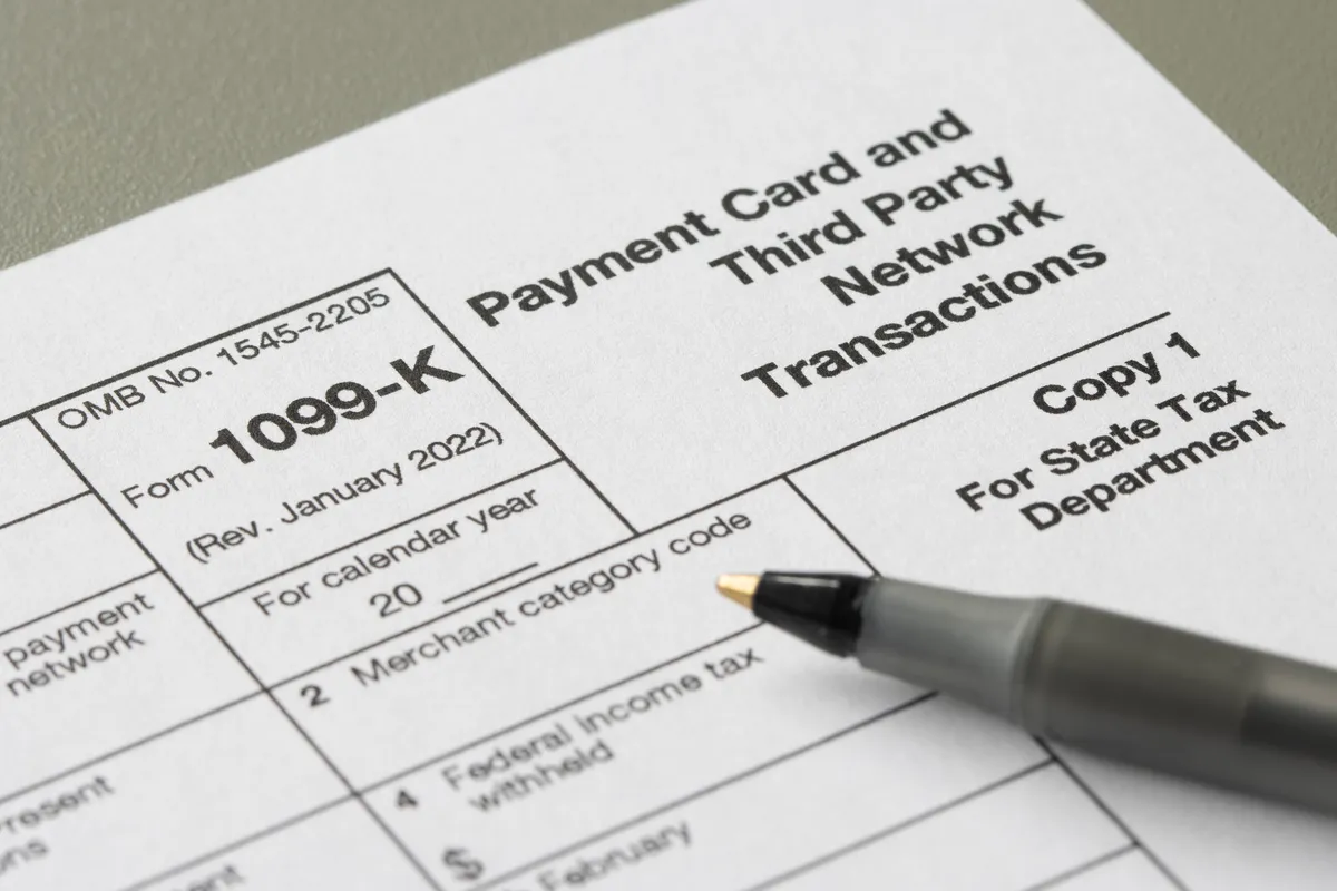 Freelancer reviewing a 1099 tax form and calculating self-employment taxes